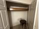 This walk-in closet offers ample storage space, with high shelves, a hanging rack, and space for a chair at 7194 Johns Point Ct, Liberty, NC 27298