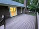 Wood planked deck with sliding glass door to home interior and brick chimney at 7194 Johns Point Ct, Liberty, NC 27298