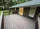Back deck featuring wood plank floor and view of the home's brick exterior at 7194 Johns Point Ct, Liberty, NC 27298