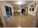 Bright dining area with wood floors, sliding glass doors, and view to kitchen at 7194 Johns Point Ct, Liberty, NC 27298