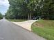 Street view of long driveway leading to the home with vehicles parked at 7194 Johns Point Ct, Liberty, NC 27298