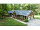 Charming brick home with a two-car garage, lush landscaping, and mature trees at 7194 Johns Point Ct, Liberty, NC 27298