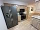 Modern kitchen with stainless steel refrigerator, microwave, and light wood cabinets at 7194 Johns Point Ct, Liberty, NC 27298