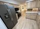 Modern kitchen with gray appliances, granite countertops, and light wood cabinets at 7194 Johns Point Ct, Liberty, NC 27298