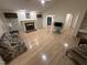 Bright living room featuring hardwood floors, a fireplace, and plenty of natural light at 7194 Johns Point Ct, Liberty, NC 27298