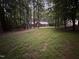Secluded home nestled among trees, offering privacy and a peaceful setting at 7194 Johns Point Ct, Liberty, NC 27298