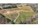 Scenic aerial shot of fenced paddocks and open green pastures ideal for equestrian activities at 756 Epps Clark Rd, Siler City, NC 27344