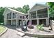 Backyard oasis with stone patio, fire pit, Adirondack chairs, multi-level decks and screened porch offering relaxation at 756 Epps Clark Rd, Siler City, NC 27344