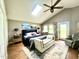 Bright main bedroom features a vaulted ceiling, a skylight, and direct access to the outdoor patio at 756 Epps Clark Rd, Siler City, NC 27344