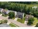 Aerial view of a two-story brick home nestled among mature trees in a well-maintained neighborhood at 8106 Sommerwell St, Raleigh, NC 27613