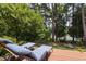 Backyard deck with lake view, perfect for relaxation, with lounge chairs for enjoying the scenery at 8106 Sommerwell St, Raleigh, NC 27613