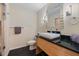 Modern bathroom featuring a vessel sink, black countertops, and contemporary fixtures, offering style and comfort at 8106 Sommerwell St, Raleigh, NC 27613
