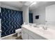 Bright bathroom with a double vanity, decorative mirror, and modern fixtures, offering comfort and style at 8106 Sommerwell St, Raleigh, NC 27613