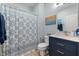 Cozy bathroom featuring a shower with a patterned curtain and a vanity with a white countertop at 8106 Sommerwell St, Raleigh, NC 27613