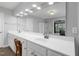 Bathroom with a double vanity, a large mirror, and a glass-enclosed shower at 8106 Sommerwell St, Raleigh, NC 27613