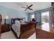 Spacious primary bedroom with a ceiling fan, natural light, and stylish decor, enhancing its appeal at 8106 Sommerwell St, Raleigh, NC 27613
