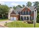 Beautiful two-story brick home with a manicured lawn, two-car garage, and a welcoming front porch at 8106 Sommerwell St, Raleigh, NC 27613