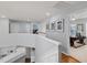 Bright hallway with white trim, hardwood floors, and access to an office space at 8106 Sommerwell St, Raleigh, NC 27613