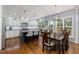 Modern kitchen boasts granite countertops, an island with seating, and an adjacent dining area at 8106 Sommerwell St, Raleigh, NC 27613