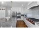 Updated kitchen with stainless appliances, granite counters, and ample cabinet space at 8106 Sommerwell St, Raleigh, NC 27613