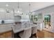 Updated kitchen boasts stainless steel appliances, granite counters, island and door to the deck at 8106 Sommerwell St, Raleigh, NC 27613