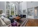 Spacious living room with large windows, a fireplace, and comfortable seating, perfect for relaxation at 8106 Sommerwell St, Raleigh, NC 27613