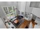 High-ceiling living room with large windows, fireplace, and hardwood floors at 8106 Sommerwell St, Raleigh, NC 27613