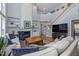Bright, open living room with fireplace, built-in shelving, and staircase leading to the second floor at 8106 Sommerwell St, Raleigh, NC 27613