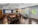Inviting living space with a dining area, projector screen, and gleaming hardwood floors for comfortable living and entertaining at 8106 Sommerwell St, Raleigh, NC 27613