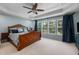 Spacious bedroom with a ceiling fan, a decorative ceiling, and plenty of natural light at 8106 Sommerwell St, Raleigh, NC 27613