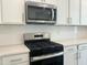 Kitchen features stainless steel appliances, white subway tile backsplash, and quartz countertops at 817 Kensley Grove Ln # 16, Fuquay Varina, NC 27526