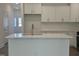 Kitchen island with quartz countertops and stainless steel faucet with a full kitchen in background at 817 Kensley Grove Ln # 16, Fuquay Varina, NC 27526