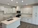 Spacious kitchen features white cabinets, stainless steel appliances, and a kitchen island at 817 Kensley Grove Ln # 16, Fuquay Varina, NC 27526