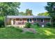 The backyard shows a brick house with a new wooden deck, some landscaping, and lawn at 827 Union St, Cary, NC 27511