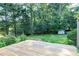 Backyard view featuring a wooden deck, well maintained lawn, and mature trees at 827 Union St, Cary, NC 27511