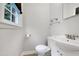 Bright half bath featuring a window, white fixtures and neutral paint at 827 Union St, Cary, NC 27511