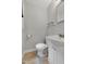 Bright half bath featuring a window, white fixtures and neutral paint at 827 Union St, Cary, NC 27511