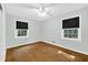 Well-lit bedroom with hardwood floors, neutral paint, and two windows at 827 Union St, Cary, NC 27511
