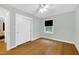 Bedroom with hardwood floors, neutral paint, closet, and bright window at 827 Union St, Cary, NC 27511