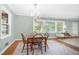 Dining room featuring a chandelier, hardwood floors, neutral paint, and view to the living area at 827 Union St, Cary, NC 27511
