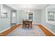 Dining room featuring a chandelier, hardwood floors, neutral paint, and bright windows at 827 Union St, Cary, NC 27511