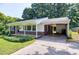 Charming ranch-style home with well-manicured lawn, covered porch, and covered parking at 827 Union St, Cary, NC 27511