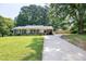 Charming ranch-style home with well-manicured lawn, covered porch, and long driveway at 827 Union St, Cary, NC 27511
