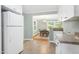Eat-in kitchen with white cabinets, appliances opens to the formal dining room at 827 Union St, Cary, NC 27511