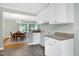 Eat-in kitchen with white cabinets, appliances opens to the formal dining room at 827 Union St, Cary, NC 27511
