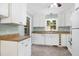 Kitchen features white cabinets, appliances, and a window overlooking the backyard at 827 Union St, Cary, NC 27511