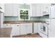 Charming kitchen with white appliances, ample cabinet space and a view to the backyard at 827 Union St, Cary, NC 27511
