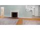 Bright living room featuring a decorative fireplace, hardwood floors, neutral paint, and an open layout at 827 Union St, Cary, NC 27511