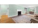 Bright living room featuring a decorative fireplace, hardwood floors, and neutral paint at 827 Union St, Cary, NC 27511