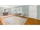 Bright living room featuring a decorative fireplace, hardwood floors, neutral paint, and view to the dining area at 827 Union St, Cary, NC 27511